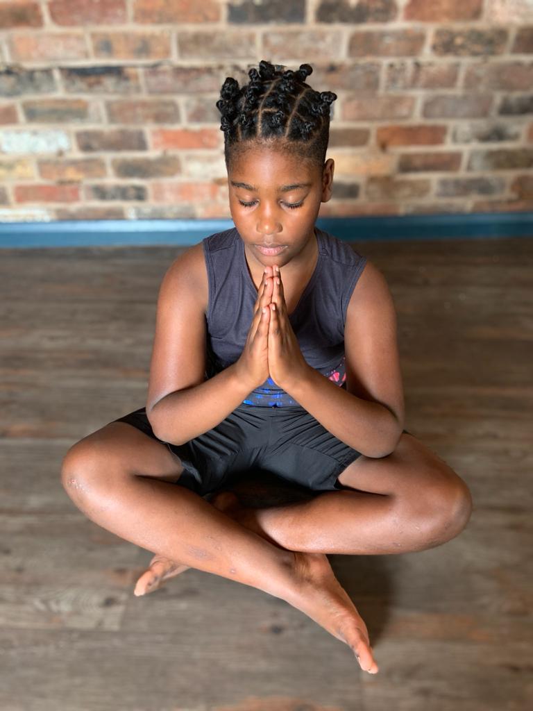child in a mindfulness pose